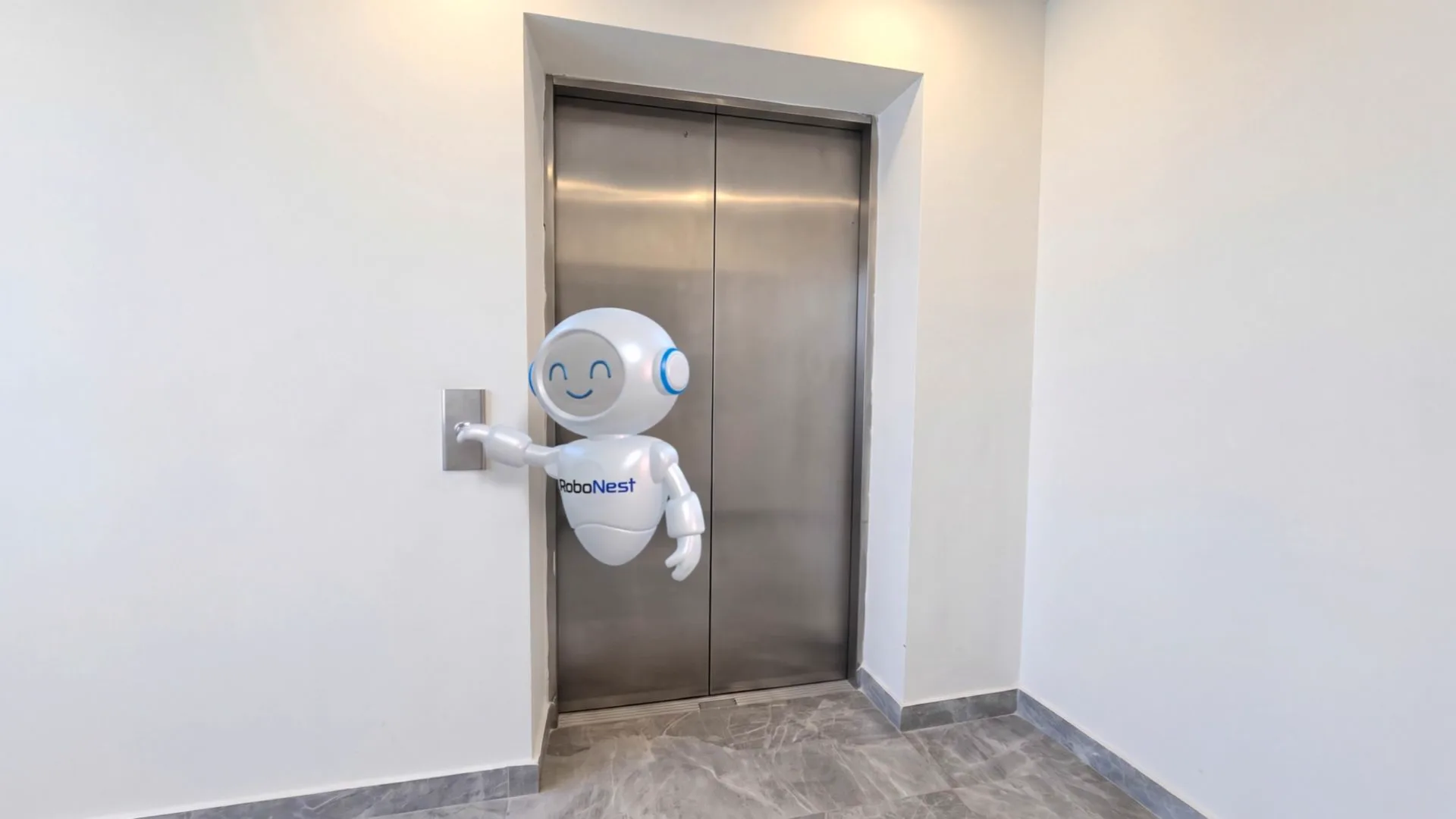 The RoboNest assistant robot in the elevator lobby of the Kartal office, in front of the call button.